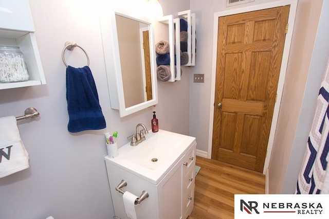 bathroom featuring visible vents, wood finished floors, and vanity