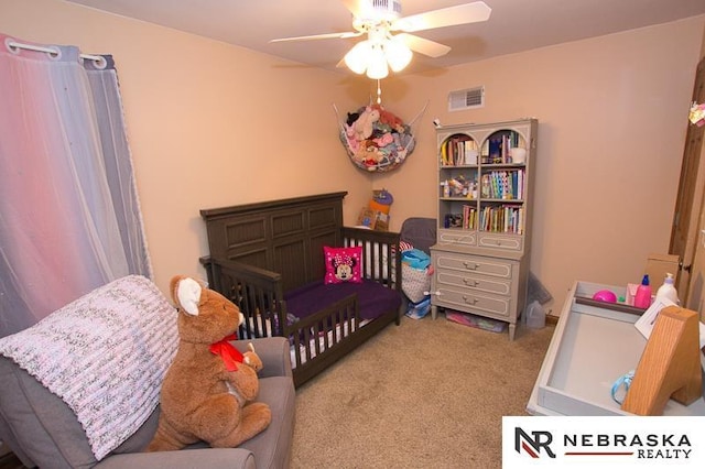 carpeted bedroom featuring a ceiling fan and visible vents