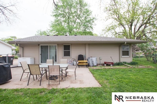 back of property featuring a lawn, fence, and a patio area