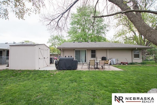 back of house with fence, a patio, a lawn, and a shed