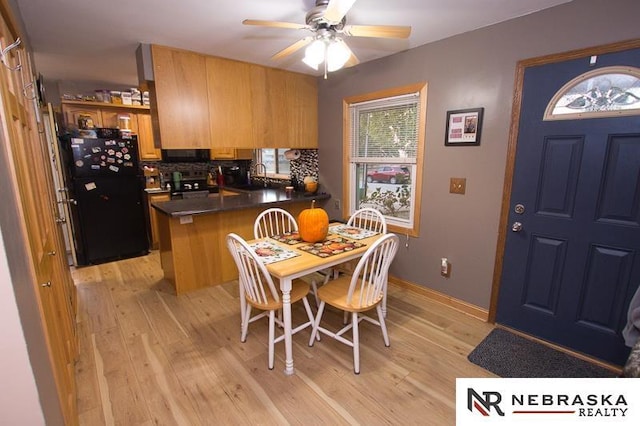 dining room with light wood-style floors, baseboards, and a ceiling fan