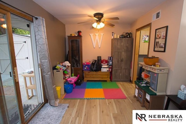 game room with visible vents, ceiling fan, and wood finished floors