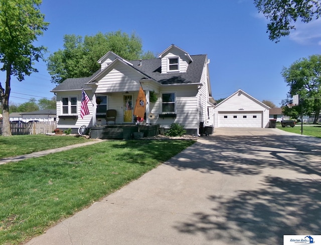view of front of house with a shingled roof, a garage, a porch, a front yard, and an outbuilding