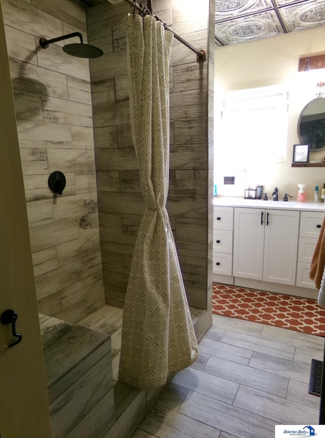 bathroom featuring vanity and tiled shower