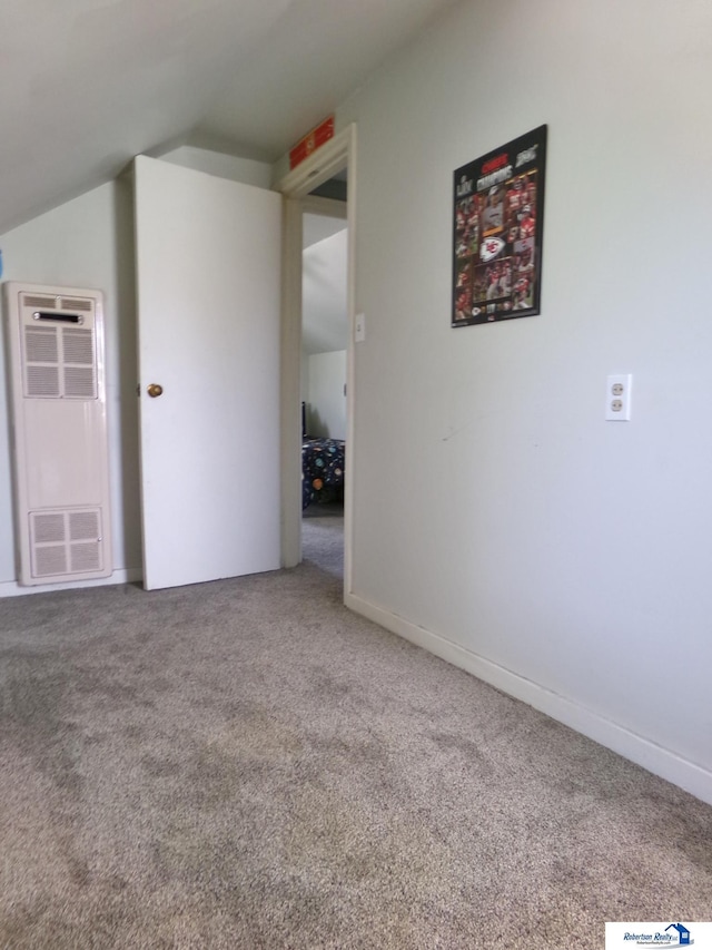 additional living space featuring baseboards, a heating unit, carpet, and vaulted ceiling