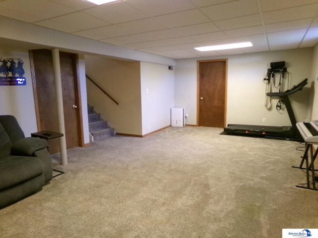 workout area with carpet and a paneled ceiling