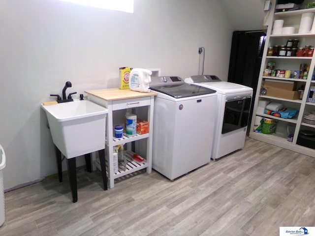 laundry room featuring laundry area, independent washer and dryer, and light wood-type flooring