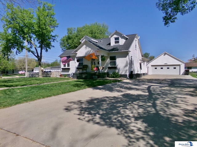 view of front of house featuring a garage, an outdoor structure, driveway, and a front lawn