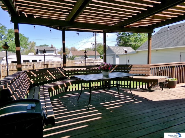 wooden deck featuring fence and a pergola