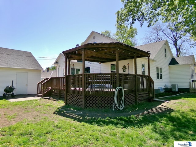 back of house with a yard, central AC, and a deck