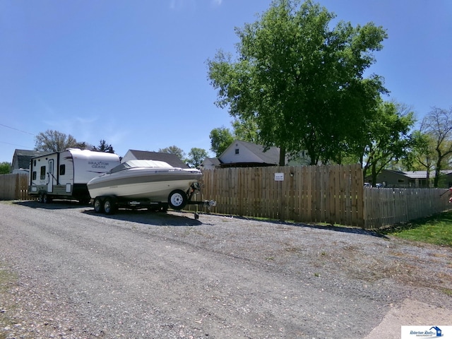 view of parking / parking lot featuring fence