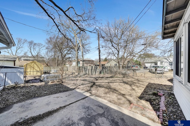 view of yard with fence, a patio, and a residential view