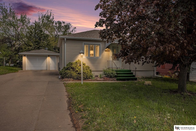 4230 N 11th St, Lincoln, NE 68521 - bungalow-style house with a detached garage, roof with shingles, an outbuilding, and a front lawn