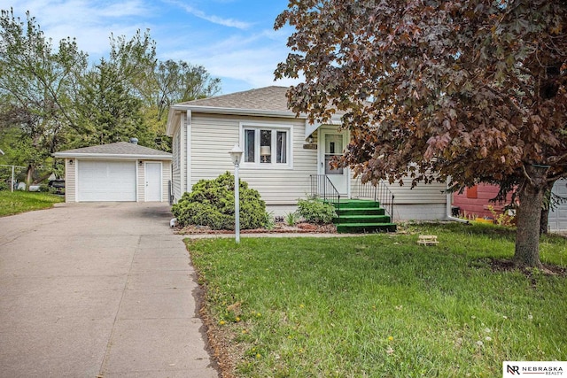 4230 N 11th St, Lincoln, NE 68521 - view of front of property featuring a garage, roof with shingles, an outdoor structure, and a front lawn