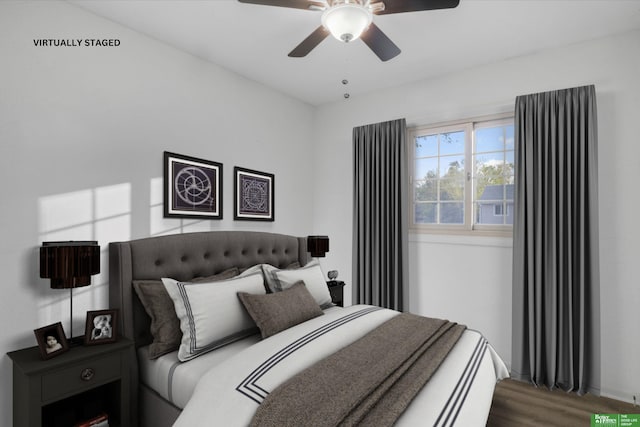 bedroom with a ceiling fan, baseboards, and wood finished floors