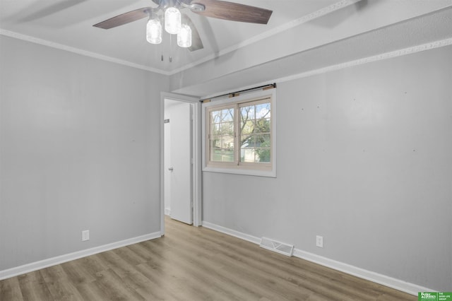 unfurnished room with a ceiling fan, baseboards, visible vents, and wood finished floors