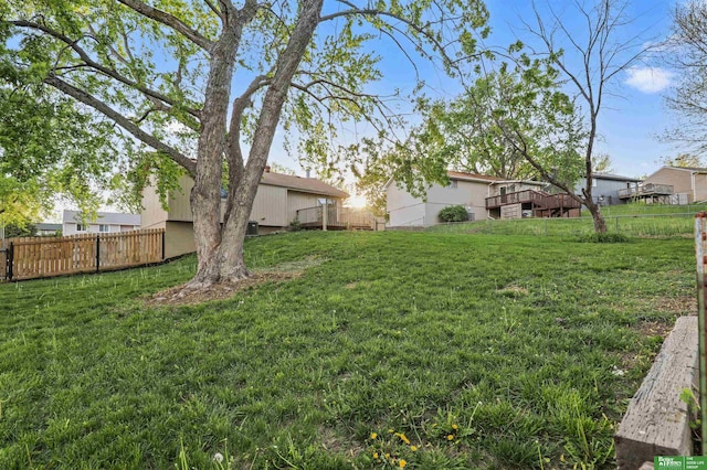 view of yard featuring fence and a wooden deck