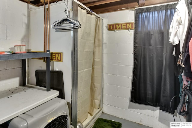 bathroom featuring concrete flooring and a shower stall