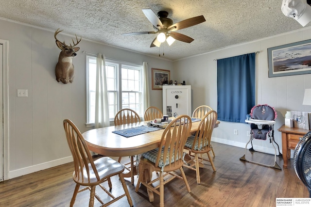 dining area with crown molding, a ceiling fan, a textured ceiling, and wood finished floors