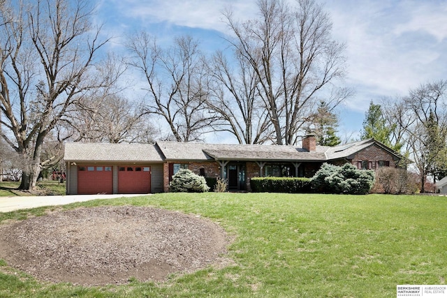 ranch-style house featuring a chimney, an attached garage, concrete driveway, and a front yard