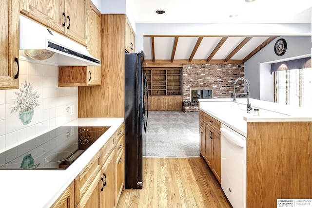 kitchen with light countertops, lofted ceiling with beams, black appliances, open floor plan, and under cabinet range hood