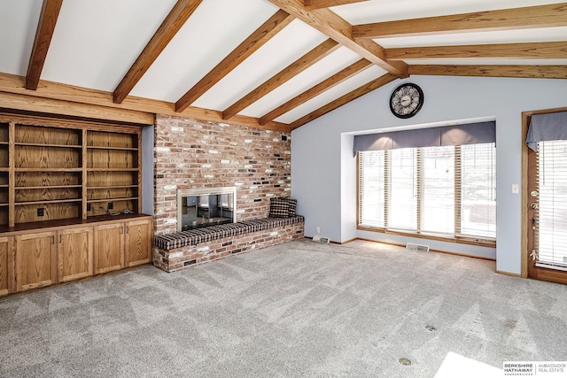unfurnished living room featuring carpet flooring, baseboards, lofted ceiling with beams, and a brick fireplace
