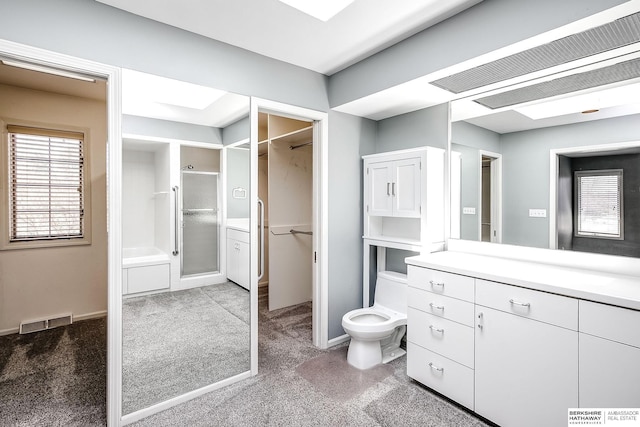 bathroom with vanity, baseboards, visible vents, and a stall shower