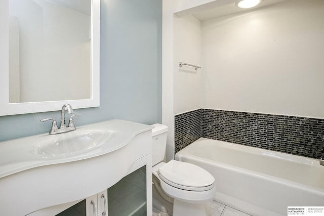 bathroom featuring vanity, tile patterned floors, toilet, and a washtub