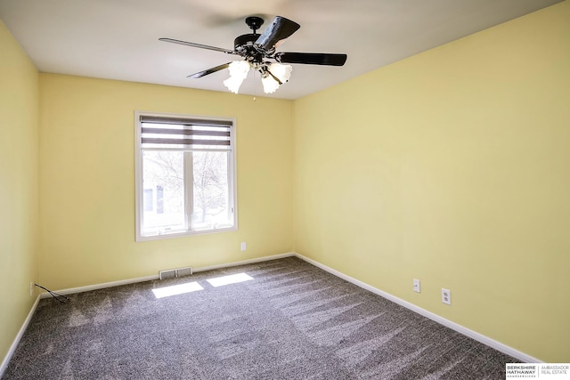 carpeted empty room with visible vents, baseboards, and ceiling fan