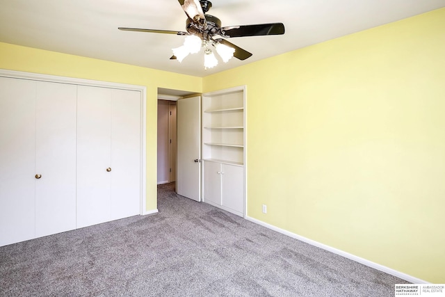 unfurnished bedroom featuring a closet, baseboards, a ceiling fan, and carpet flooring