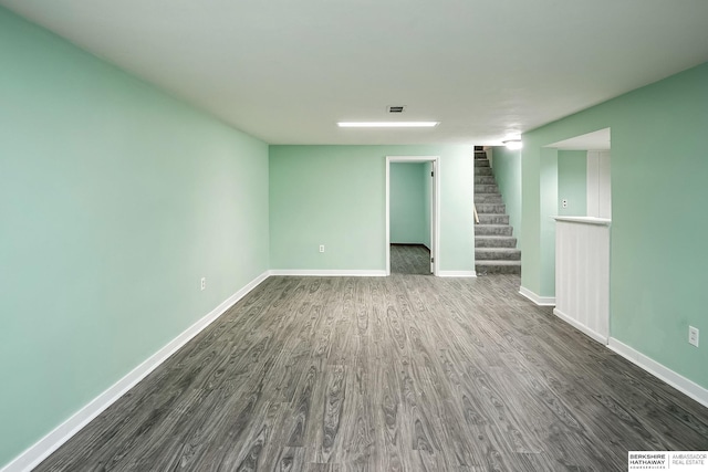 interior space with baseboards, dark wood-style floors, stairway, and visible vents