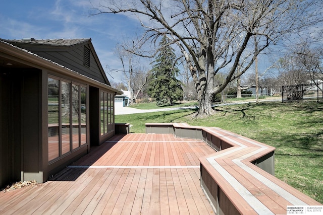 deck featuring fence and a yard