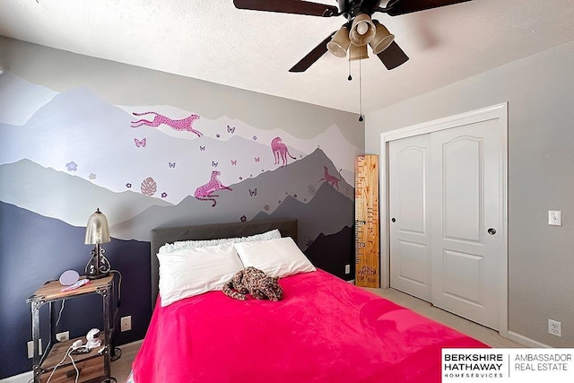 bedroom featuring baseboards, ceiling fan, a closet, and carpet flooring
