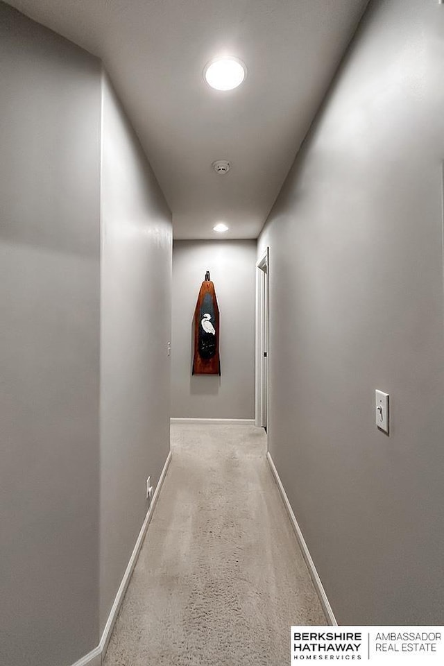 hall featuring baseboards and recessed lighting