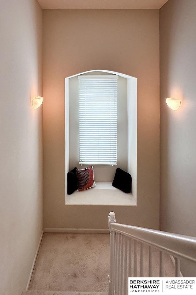interior space with carpet flooring and baseboards