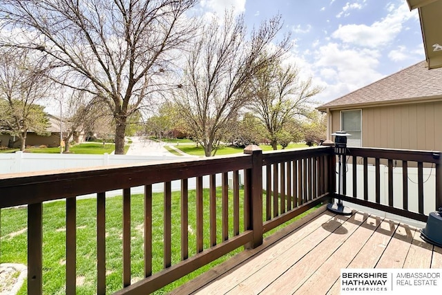 wooden deck with a lawn