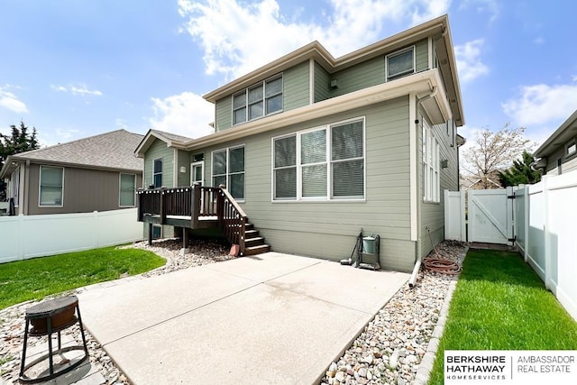rear view of property with a yard, a fenced backyard, a gate, and a patio area