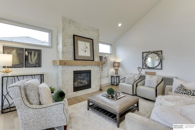living room with high vaulted ceiling, a fireplace, recessed lighting, and wood finished floors