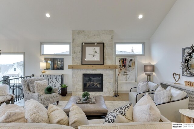 living area featuring recessed lighting, vaulted ceiling, wood finished floors, and a fireplace