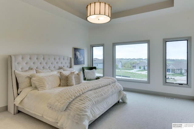 bedroom with visible vents and light colored carpet