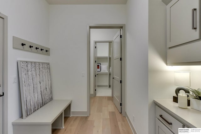 mudroom with baseboards and light wood-type flooring