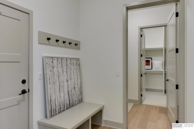 mudroom featuring baseboards and light wood finished floors