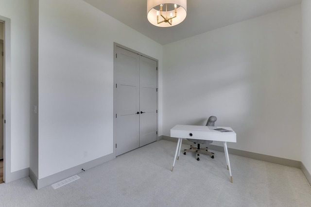 unfurnished office featuring carpet floors, baseboards, and visible vents