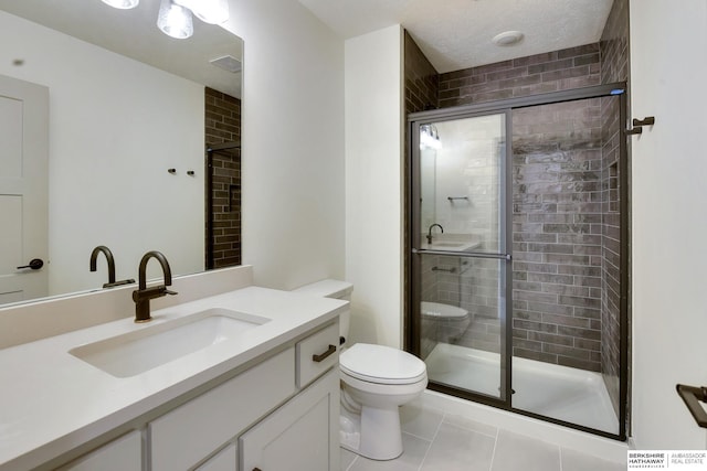 bathroom featuring tile patterned flooring, vanity, toilet, and a shower stall