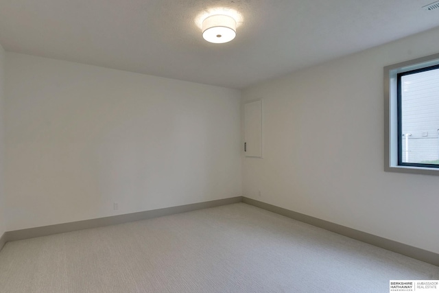unfurnished room with light colored carpet, baseboards, and visible vents