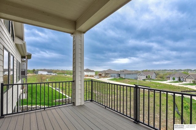 deck with a yard and a residential view
