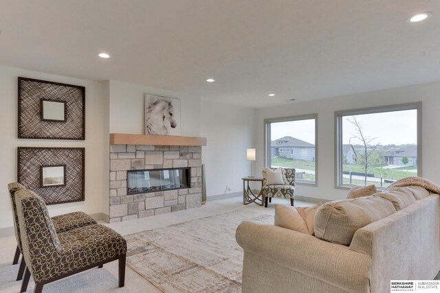 living area featuring recessed lighting, light colored carpet, and a fireplace