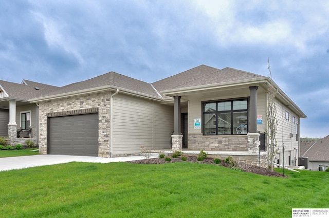 view of front of property with roof with shingles, a front lawn, concrete driveway, an attached garage, and stone siding