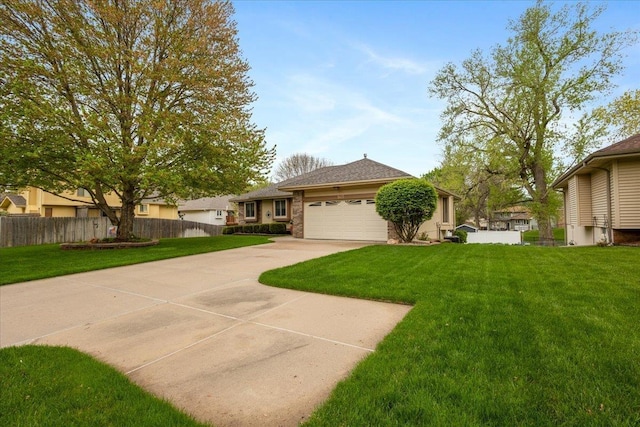 single story home featuring fence, concrete driveway, a front yard, and a garage