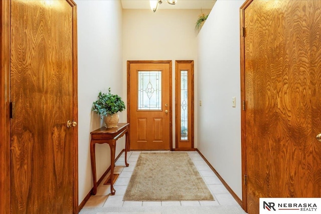 entryway featuring light tile patterned flooring and baseboards